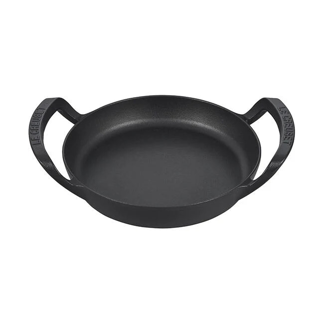 A black cast iron skillet with ergonomic handles.