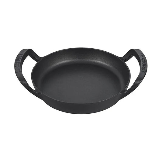 A black cast iron skillet with ergonomic handles.
